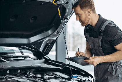 Car mechanic at car service checking up the car