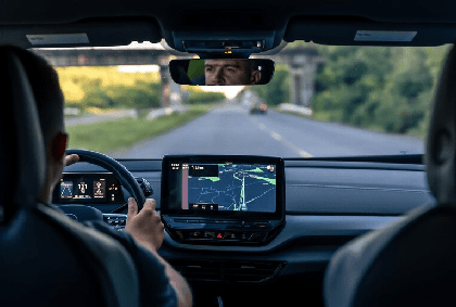 Man touching screen of a GPS navigation system in his car